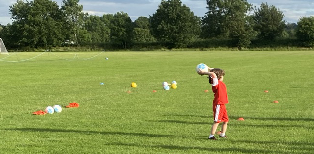 Under 8 player taking a throw-in
